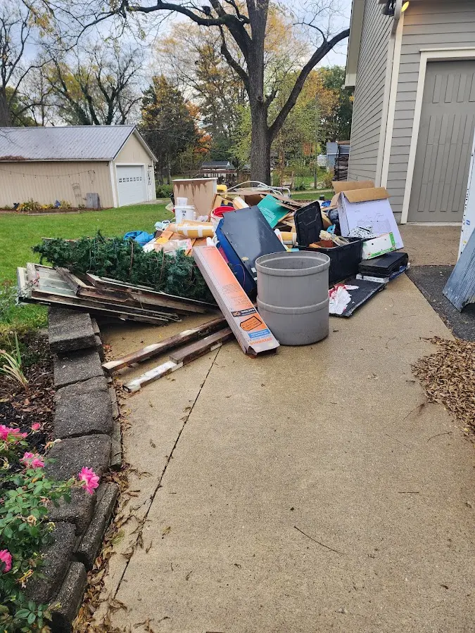 Dumpster being loaded with debris for Roofing Dumpster Rental in Seven Hills